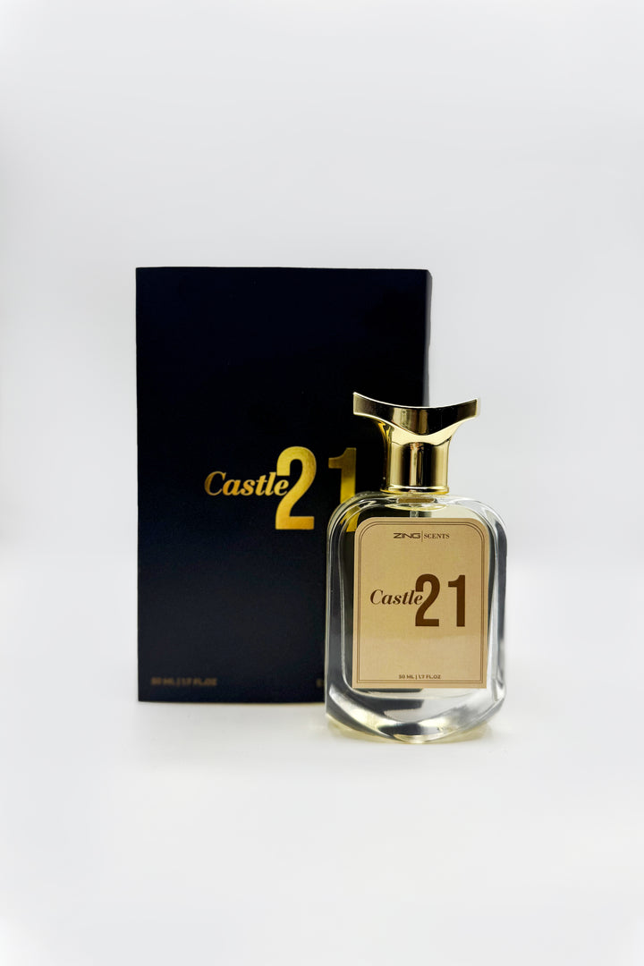 Castle 21 perfume bottle in front of its premium black packaging displayed on white background