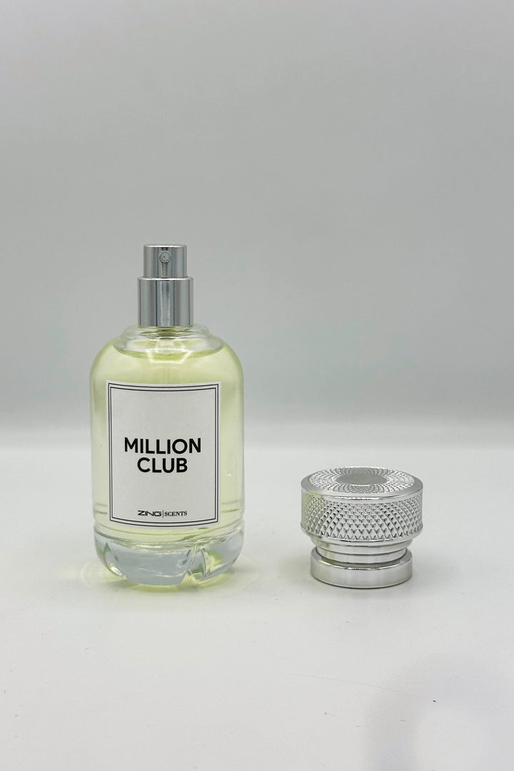Million club perfume bottle with its silver textured lid placed beside the perfume bottle displayed on a white background.