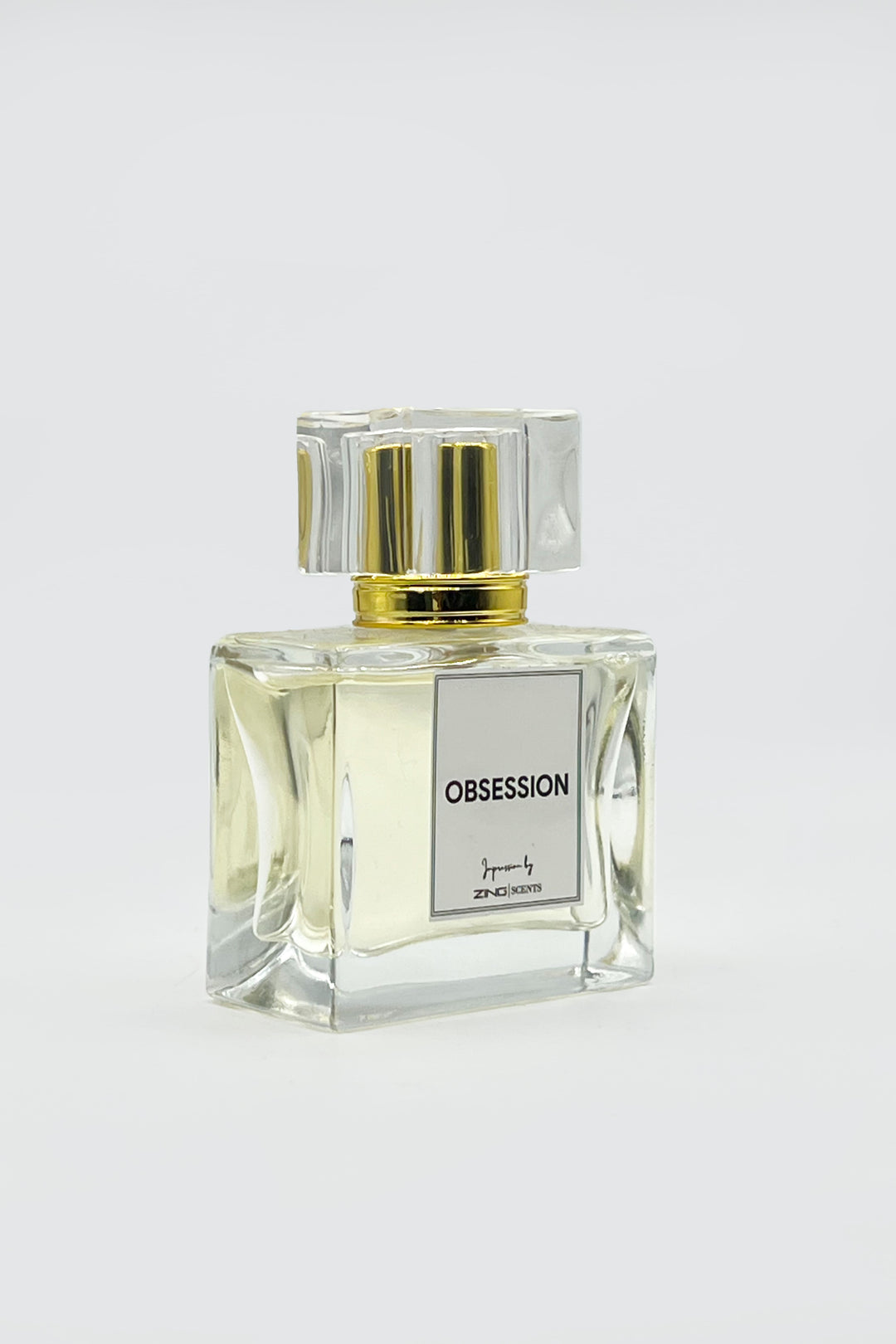 obsession perfume bottles with golden sprayer displayed on grey background