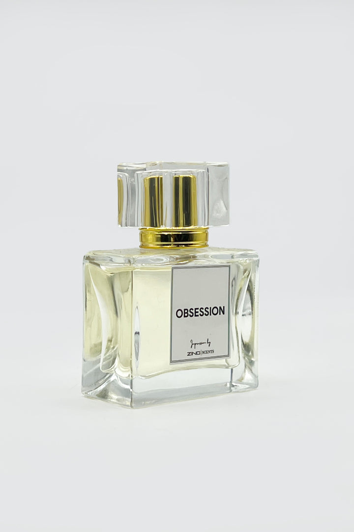 obsession perfume bottles with golden sprayer displayed on grey background